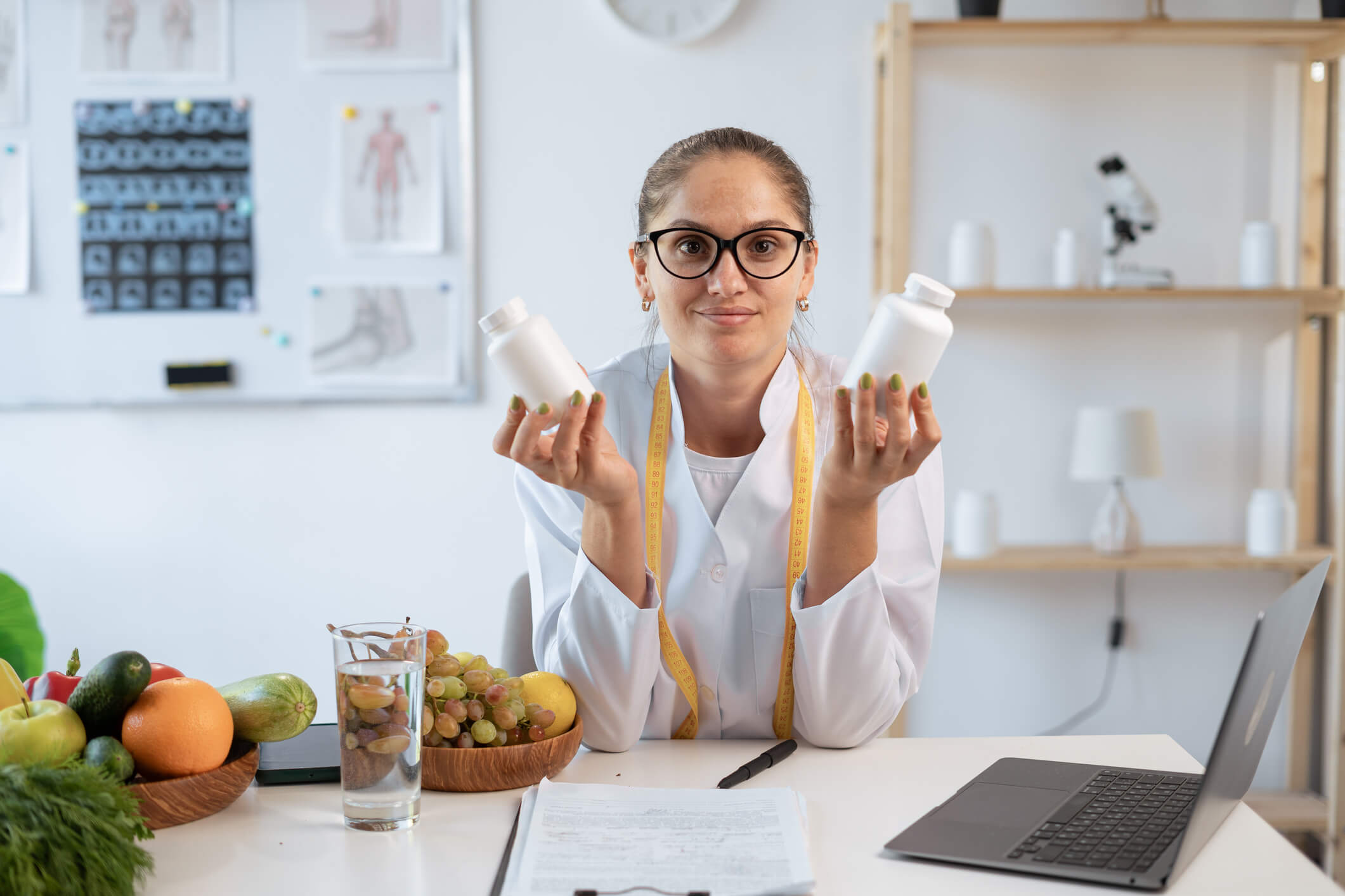 Health expert with pills and fruits